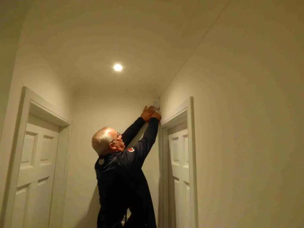 electrician fitting home intruder alarm