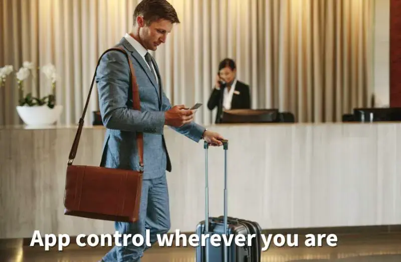 businessman in suit with luggage using app on phone - IDES controlled lighting
